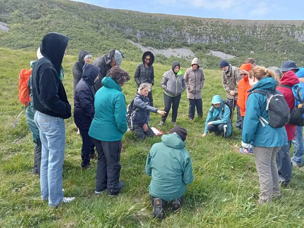 People in a field group at Slieve Carron